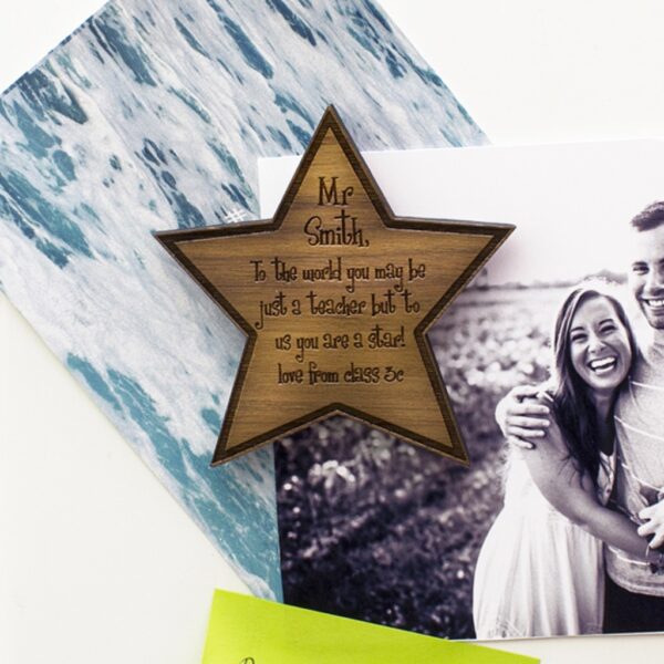 Personalised walnut wood star fridge magnet engraved with a thank-you message for a teacher.
