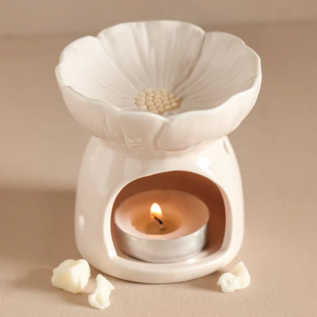 Pink Blossom ceramic wax melt burner shaped like a flower with a lit tea light inside on a neutral background by Abode Home & Gifts
