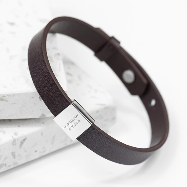 Personalised men's brown leather bracelet featuring an engraved stainless steel tag reading Our Daddy Est. 2023