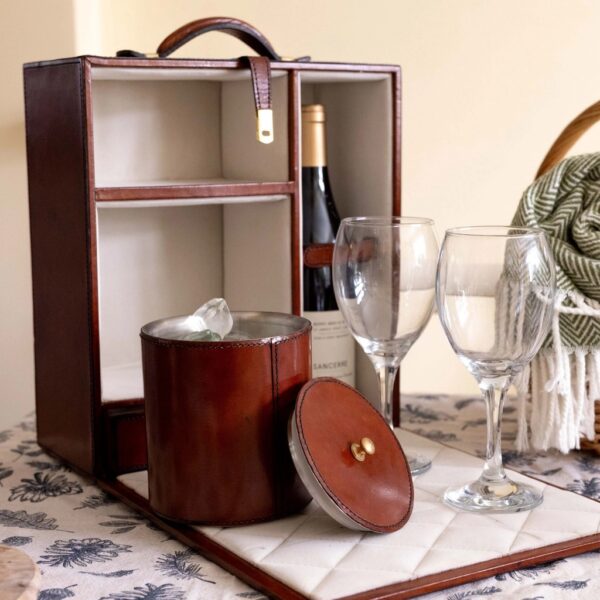 Cognac leather travelling mini bar open with leather ice bucket and wine bottle